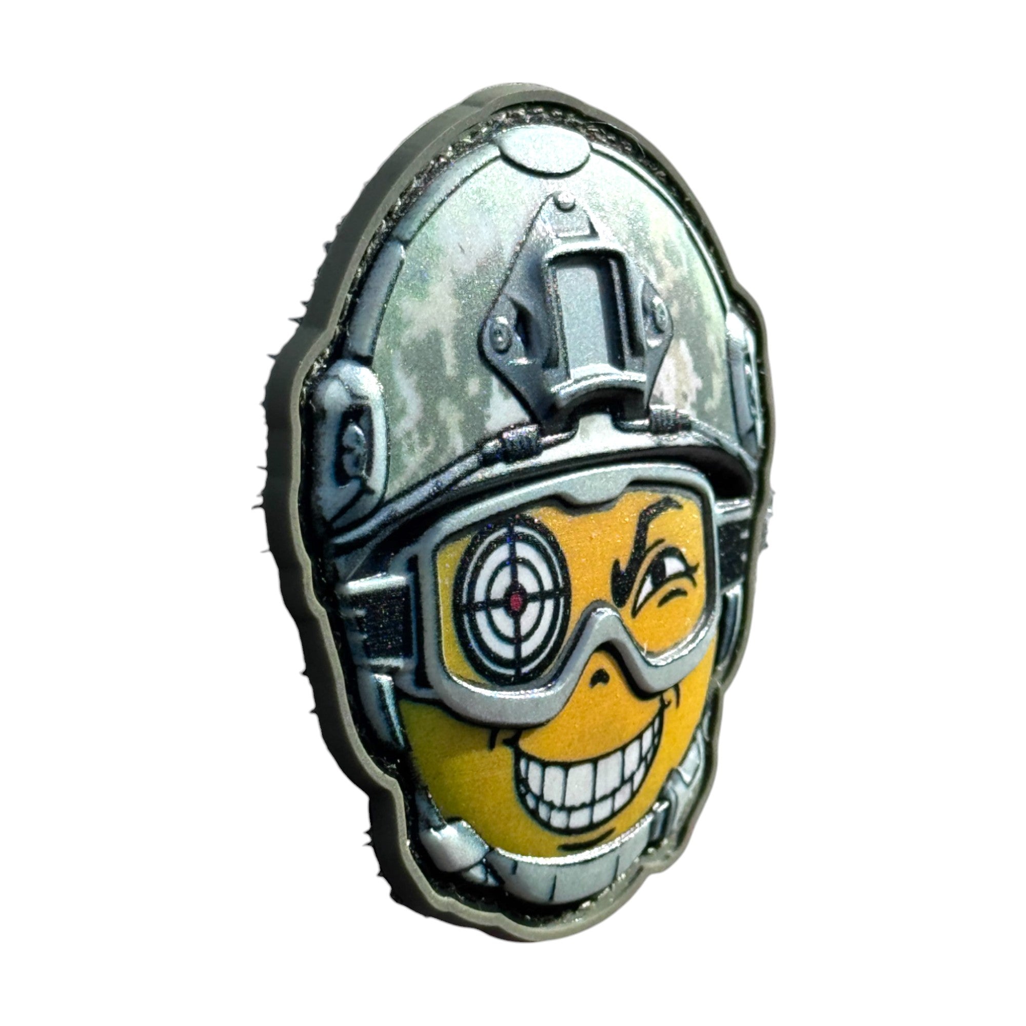 Yellow smiling emoji with an aim in its eye, wearing a combat helmet on a tactical military 3D PVC Hook and loop patch. side view. Ideal for adding a unique and fun touch to your gear.